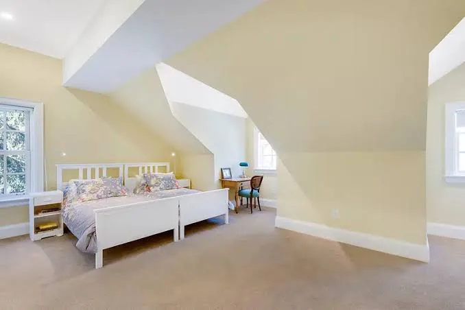 Loft bedroom with gable-end windows after a hip to gable conversion